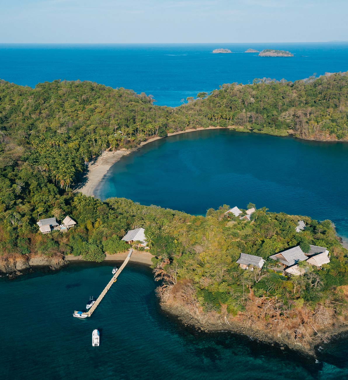 An aerial view of the harbour at Islas Secas with boats docked and entering the harbour, available for guests of the resort to rent | Islas Secas