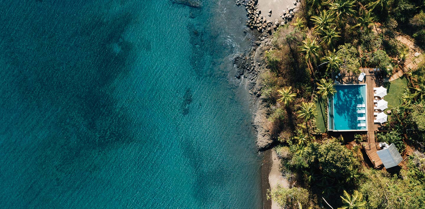 A birdseye view of the pool area overlooking the ocean at Islas Secas, a sustainable island resort off the coast of Panama | Islas Secas