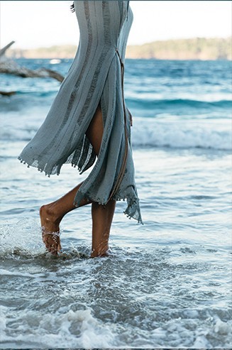 A woman treads the shallows of the ocean on the beautiful islands of the Islas Secas resort | Islas Secas