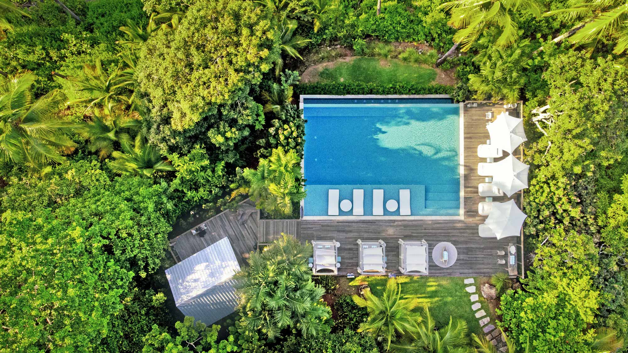 An aerial view of the pool area at Islas Secas resort, surrounded by day beds to give guests space to relax and cool off | Islas Secas